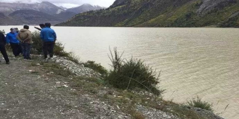 Tibetan travellers are stopped by Chinese police, who push one into a river and shoot another.